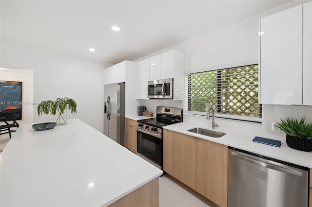 326 SW 20th Rd, Miami, FL 33129 - kitchen featuring appliances with stainless steel finishes, modern cabinets, light countertops, white cabinetry, and recessed lighting