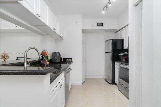 17125 N Bay Rd Unit 3104, Sunny Isles Beach, FL 33160 - kitchen featuring appliances with stainless steel finishes, white cabinetry, light tile patterned floors, and dark stone counters