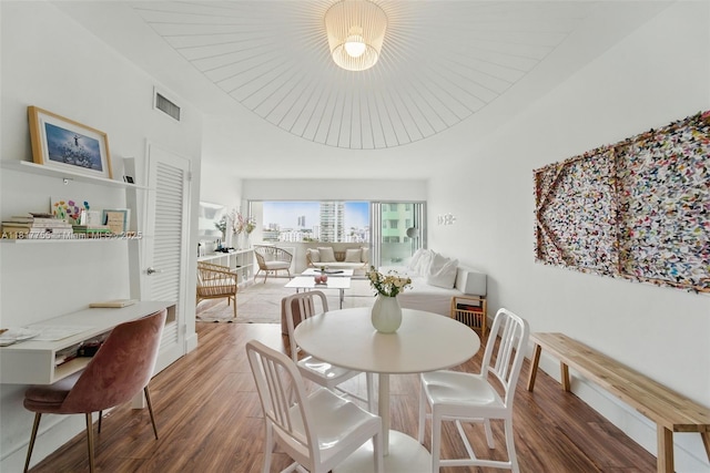3 Island Ave Unit 12J, Miami Beach, FL 33139 - dining room featuring wood finished floors and baseboards