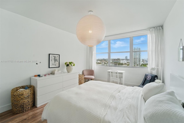 3 Island Ave Unit 12J, Miami Beach, FL 33139 - bedroom featuring wood finished floors and baseboards
