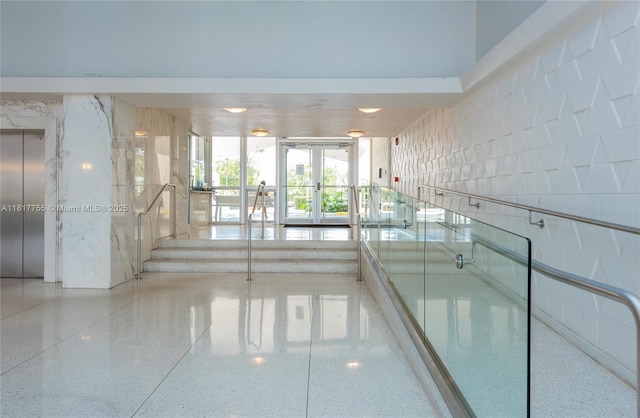3 Island Ave Unit 12J, Miami Beach, FL 33139 - corridor featuring elevator, french doors, and speckled floor