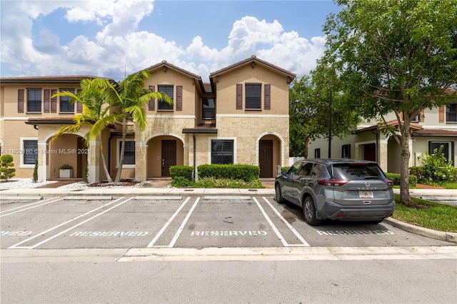 10625 W 32nd Ln, Hialeah, FL 33018 - multi unit property with stone siding, uncovered parking, and stucco siding