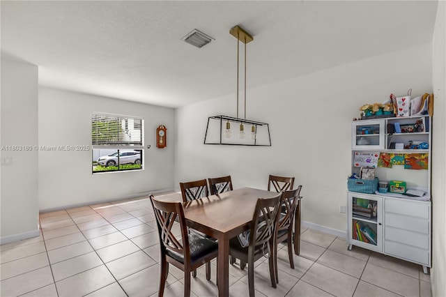 10625 W 32nd Ln, Hialeah, FL 33018 - dining area with light tile patterned floors and baseboards