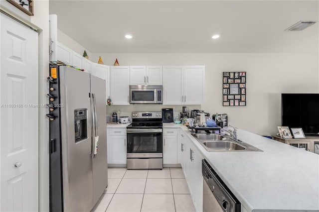 10625 W 32nd Ln, Hialeah, FL 33018 - kitchen with stainless steel appliances, a sink, a peninsula, white cabinetry, and recessed lighting