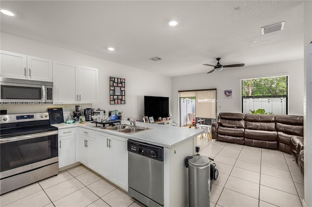 10625 W 32nd Ln, Hialeah, FL 33018 - kitchen featuring stainless steel appliances, a sink, open floor plan, a peninsula, and light tile patterned floors