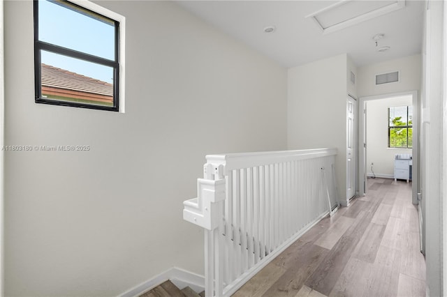 10625 W 32nd Ln, Hialeah, FL 33018 - corridor with an upstairs landing, baseboards, attic access, and light wood-type flooring