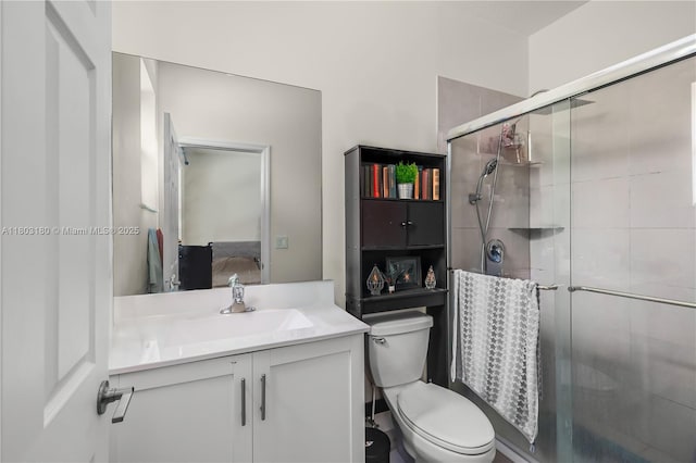 10625 W 32nd Ln, Hialeah, FL 33018 - bathroom featuring toilet, vanity, a shower stall, and ensuite bathroom