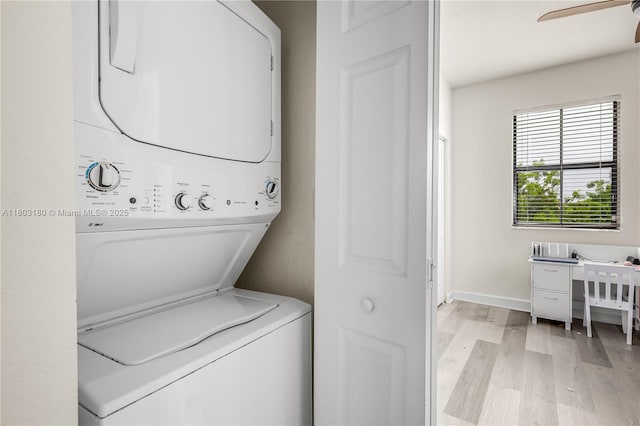 10625 W 32nd Ln, Hialeah, FL 33018 - washroom featuring stacked washer / dryer, light wood-style flooring, a ceiling fan, and baseboards