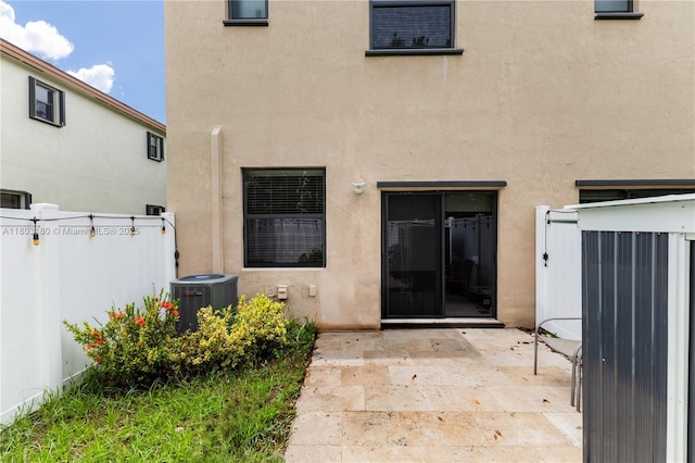 10625 W 32nd Ln, Hialeah, FL 33018 - back of property with central air condition unit, stucco siding, and a patio area