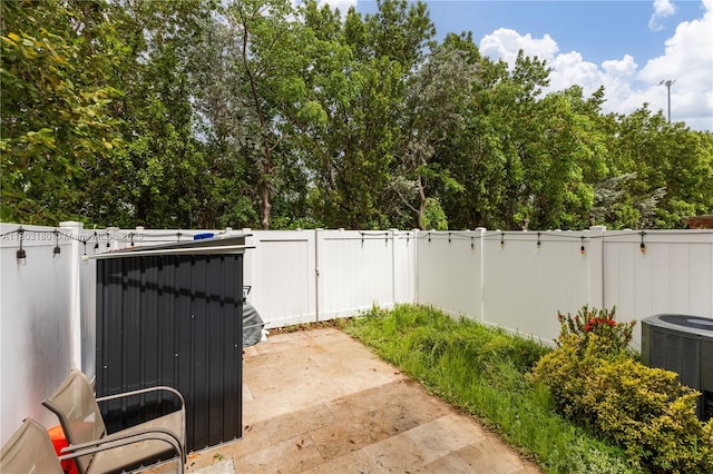 10625 W 32nd Ln, Hialeah, FL 33018 - fenced backyard with central AC, a gate, and a patio area