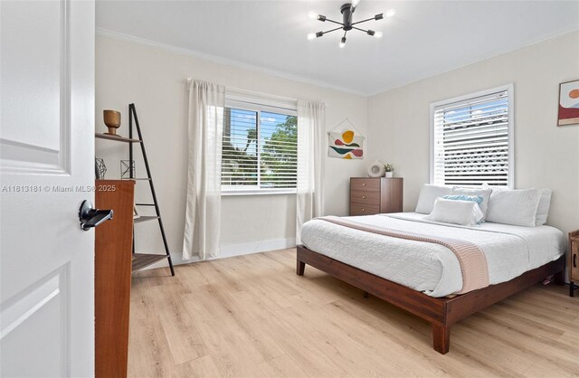 1636 Arthur St, Hollywood, FL 33020 - bedroom with a chandelier, light wood-style flooring, crown molding, and baseboards