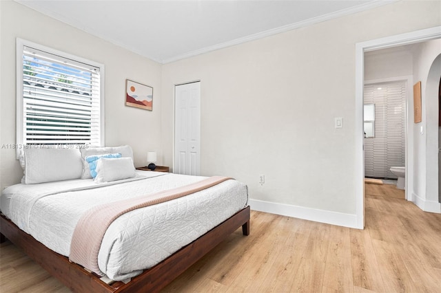 1636 Arthur St, Hollywood, FL 33020 - bedroom featuring light wood-type flooring, ornamental molding, baseboards, arched walkways, and a closet