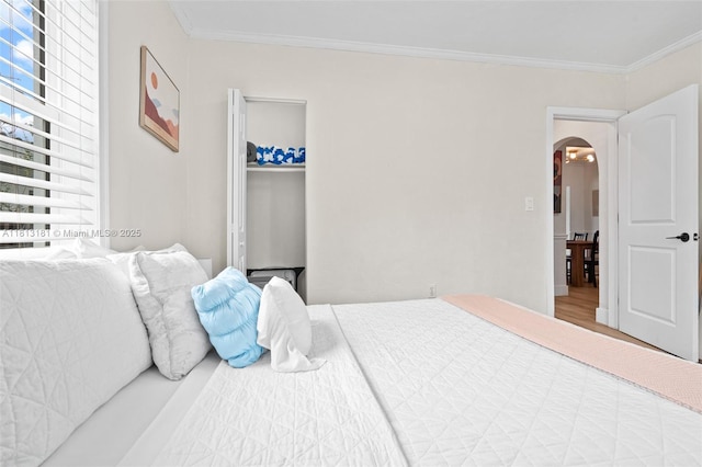 1636 Arthur St, Hollywood, FL 33020 - bedroom with arched walkways, ornamental molding, and wood finished floors