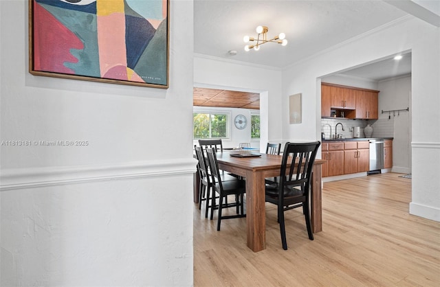 1636 Arthur St, Hollywood, FL 33020 - dining area with ornamental molding, light wood-style flooring, a chandelier, and baseboards