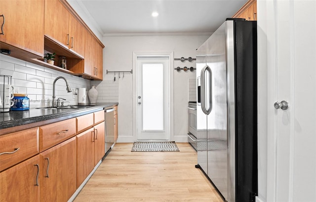 1636 Arthur St, Hollywood, FL 33020 - kitchen with appliances with stainless steel finishes, a sink, light wood-type flooring, backsplash, and ornamental molding