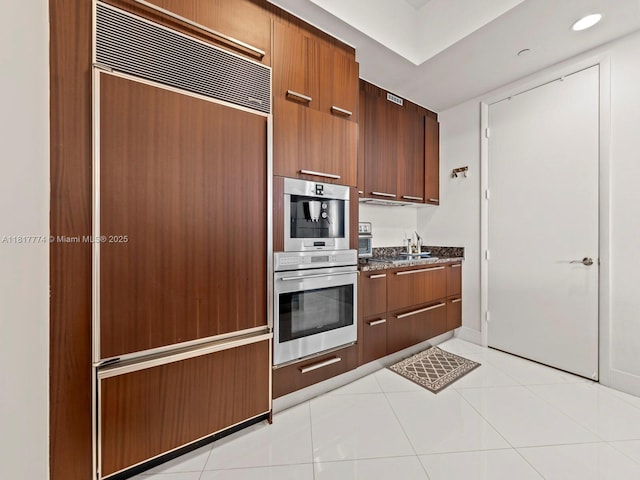 15901 Collins Ave Unit 403, Sunny Isles Beach, FL 33160 - kitchen featuring paneled built in refrigerator, modern cabinets, a sink, and dark stone counters