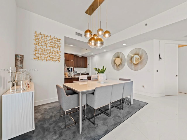 15901 Collins Ave Unit 403, Sunny Isles Beach, FL 33160 - tiled dining space with baseboards, recessed lighting, a chandelier, and a tray ceiling