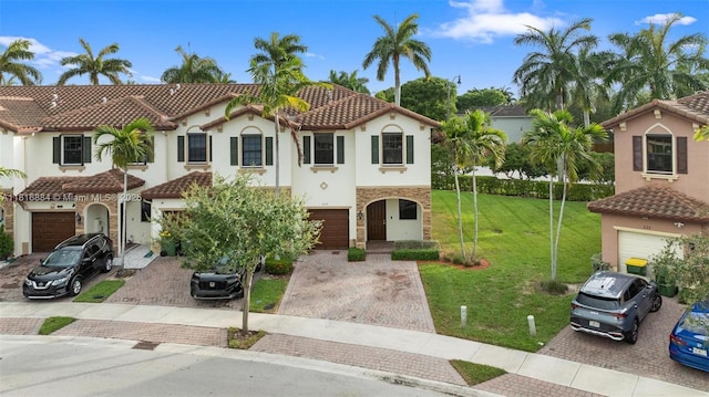 232 SE 33rd Ter, Homestead, FL 33033 - mediterranean / spanish-style house with driveway, stucco siding, a tiled roof, a front yard, and stone siding