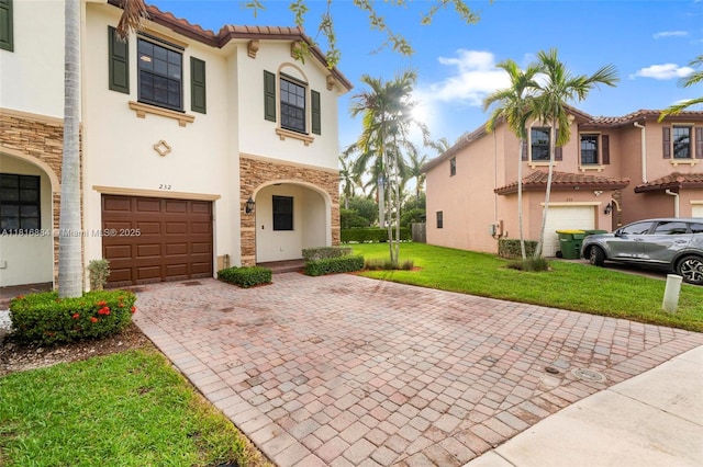 232 SE 33rd Ter, Homestead, FL 33033 - view of front facade with stucco siding, decorative driveway, an attached garage, stone siding, and a front lawn