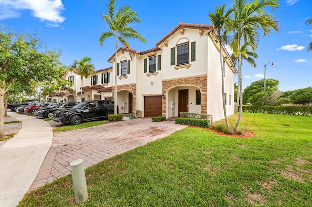 232 SE 33rd Ter, Homestead, FL 33033 - mediterranean / spanish-style home with decorative driveway, stucco siding, a garage, stone siding, and a front yard