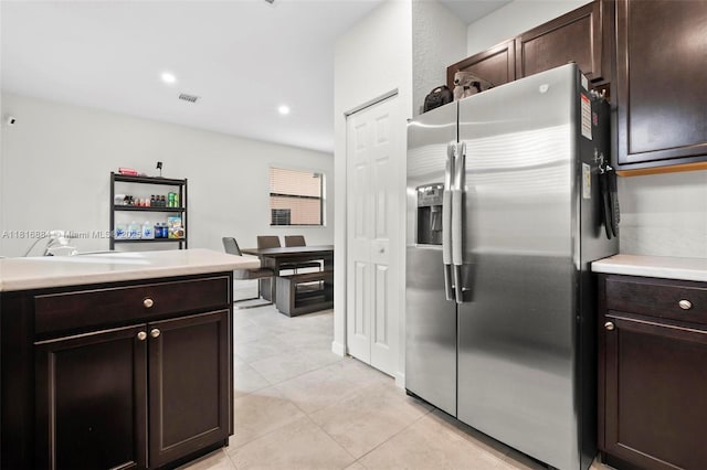 232 SE 33rd Ter, Homestead, FL 33033 - kitchen featuring stainless steel fridge with ice dispenser, light tile patterned floors, dark brown cabinets, light countertops, and recessed lighting