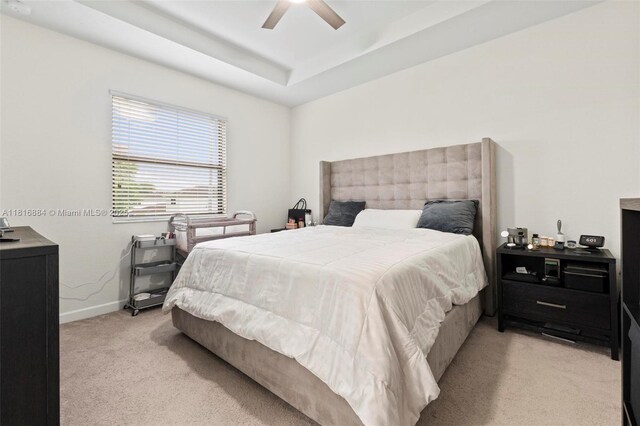 232 SE 33rd Ter, Homestead, FL 33033 - bedroom featuring light carpet, a raised ceiling, baseboards, and a ceiling fan