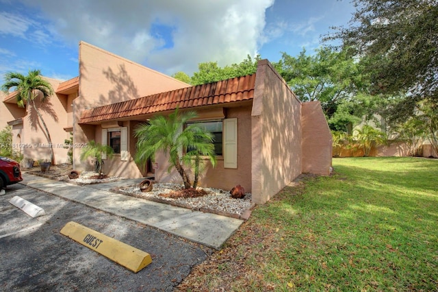 10 Seville Cir Unit 6-54, Davie, FL 33324 - pueblo-style house with stucco siding, a tile roof, and uncovered parking
