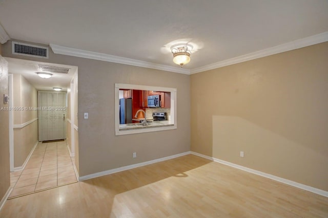 10 Seville Cir Unit 6-54, Davie, FL 33324 - spare room featuring light wood finished floors, ornamental molding, baseboards, and a sink