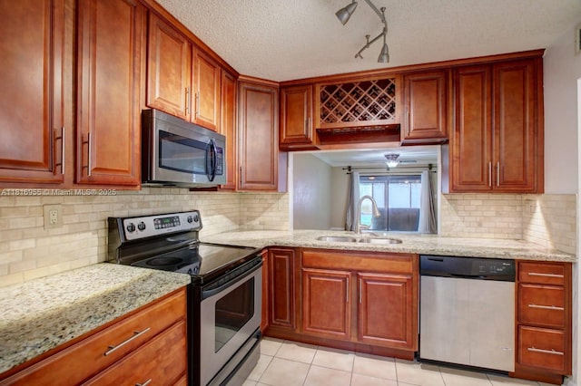 10 Seville Cir Unit 6-54, Davie, FL 33324 - kitchen with appliances with stainless steel finishes, a sink, light stone counters, and a textured ceiling