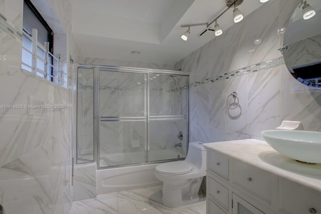 10 Seville Cir Unit 6-54, Davie, FL 33324 - bathroom with tile walls, vanity, bath / shower combo with glass door, toilet, and marble finish floors