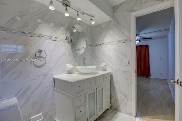 10 Seville Cir Unit 6-54, Davie, FL 33324 - bathroom featuring vanity, tile walls, and track lighting