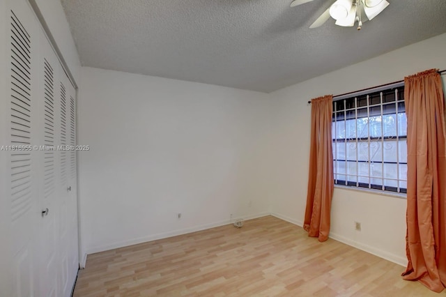 10 Seville Cir Unit 6-54, Davie, FL 33324 - unfurnished bedroom with light wood finished floors, a textured ceiling, baseboards, ceiling fan, and a closet