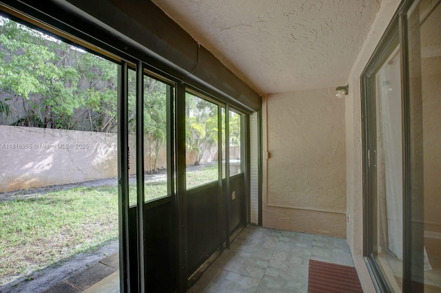 10 Seville Cir Unit 6-54, Davie, FL 33324 - unfurnished sunroom with a textured ceiling and a textured wall