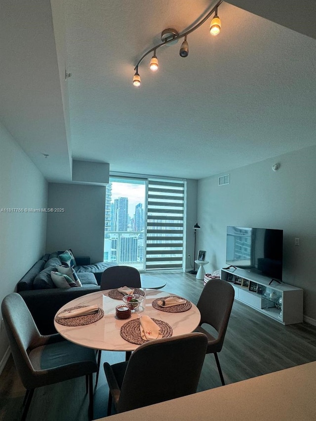 1900 N Bayshore Dr Unit 3909, Miami, FL 33132 - dining space featuring wood finished floors, baseboards, and a textured ceiling