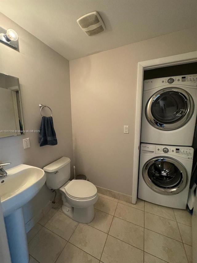 1900 N Bayshore Dr Unit 3909, Miami, FL 33132 - half bath featuring stacked washer / dryer, toilet, tile patterned flooring, and baseboards