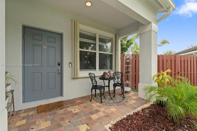 402 SE 30th Ter, Homestead, FL 33033 - doorway to property featuring stucco siding and covered porch