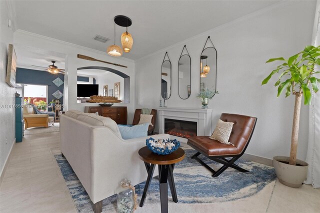402 SE 30th Ter, Homestead, FL 33033 - living room featuring a glass covered fireplace, crown molding, ceiling fan, and baseboards