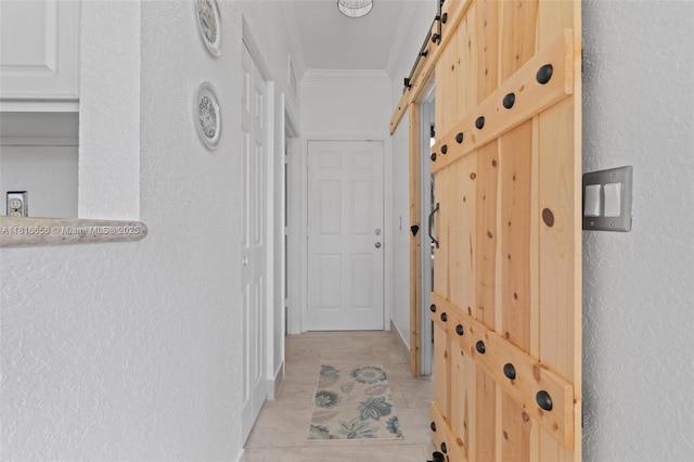 402 SE 30th Ter, Homestead, FL 33033 - corridor featuring a barn door, ornamental molding, a textured wall, and light tile patterned floors