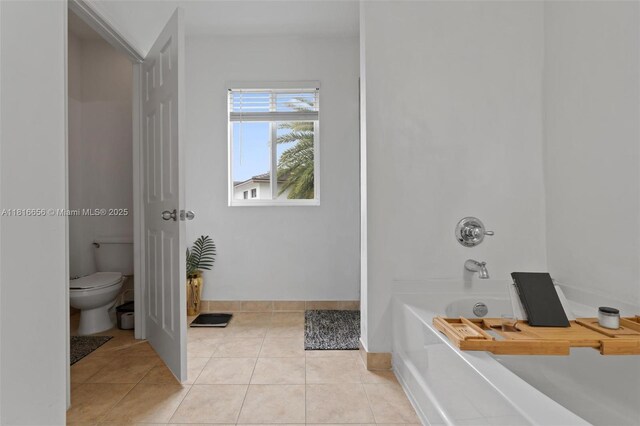 402 SE 30th Ter, Homestead, FL 33033 - bathroom with a tub, toilet, tile patterned floors, and baseboards