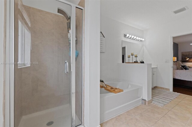 402 SE 30th Ter, Homestead, FL 33033 - bathroom featuring ensuite bathroom, a garden tub, a stall shower, tile patterned flooring, and vanity
