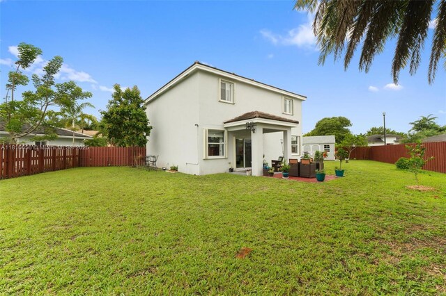 402 SE 30th Ter, Homestead, FL 33033 - rear view of house featuring an outdoor living space, stucco siding, and a patio
