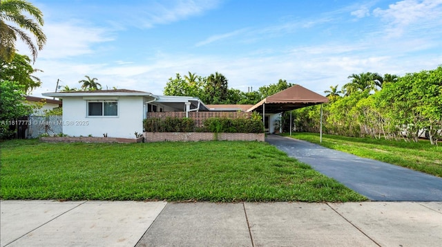 3145 Hollywood Blvd, Hollywood, FL 33021 - view of front of house featuring a carport, stucco siding, a front yard, and concrete driveway