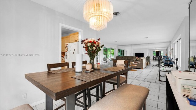 3145 Hollywood Blvd, Hollywood, FL 33021 - dining space featuring a chandelier and light tile patterned flooring
