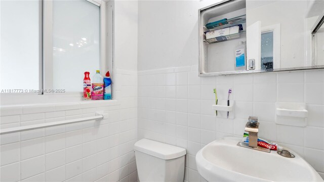 3145 Hollywood Blvd, Hollywood, FL 33021 - half bath featuring toilet, tile walls, and a sink
