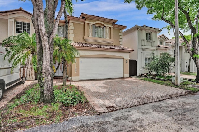 11222 NW 73rd Ter, Doral, FL 33178 - view of front of home featuring stucco siding, a tile roof, an attached garage, and decorative driveway