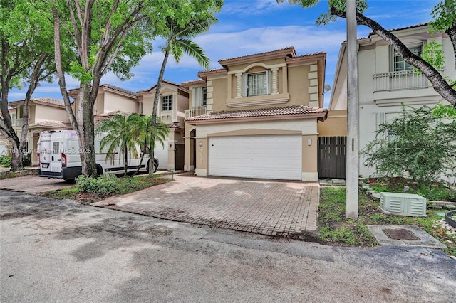 11222 NW 73rd Ter, Doral, FL 33178 - view of front facade with stucco siding, an attached garage, a tile roof, and decorative driveway