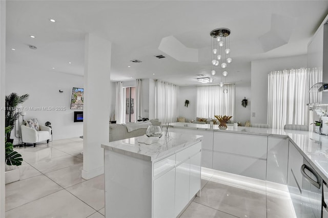 11222 NW 73rd Ter, Doral, FL 33178 - kitchen with open floor plan, modern cabinets, light stone countertops, white cabinets, and plenty of natural light
