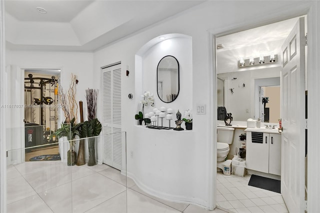 11222 NW 73rd Ter, Doral, FL 33178 - corridor with light tile patterned floors, a sink, and a tray ceiling