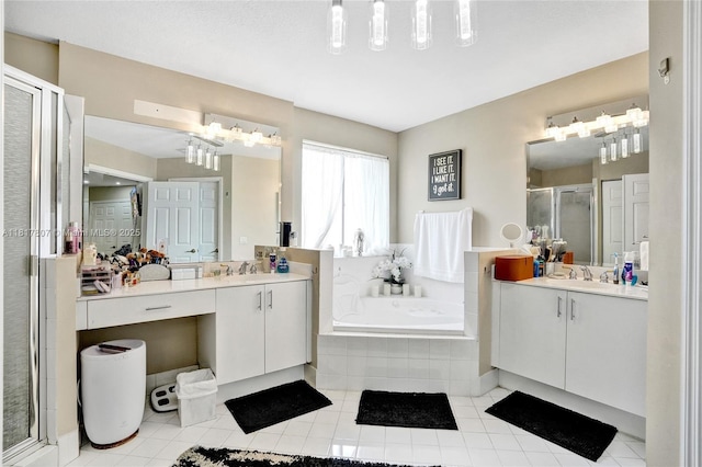 11222 NW 73rd Ter, Doral, FL 33178 - bathroom with a shower stall, a garden tub, two vanities, and tile patterned floors