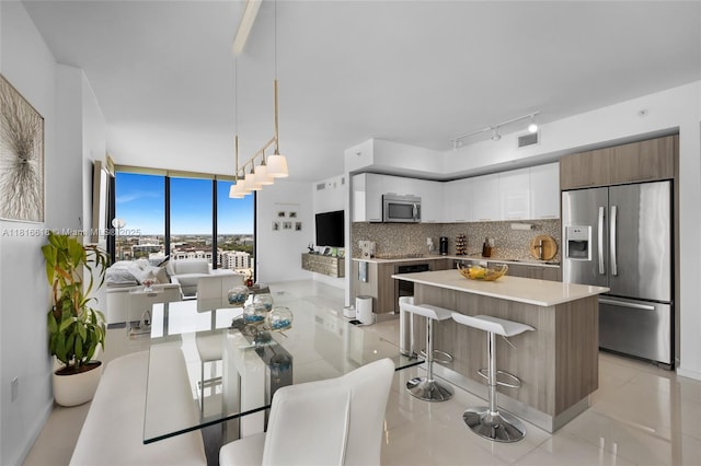 5252 NW 85th Ave Unit 1701, Doral, FL 33166 - dining space featuring light tile patterned floors and expansive windows